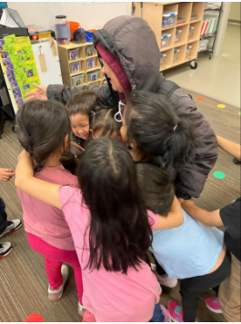 Alakanuk Elder Agnes Damian with her students. Each student gets a punch in their punch card when they return their folders.